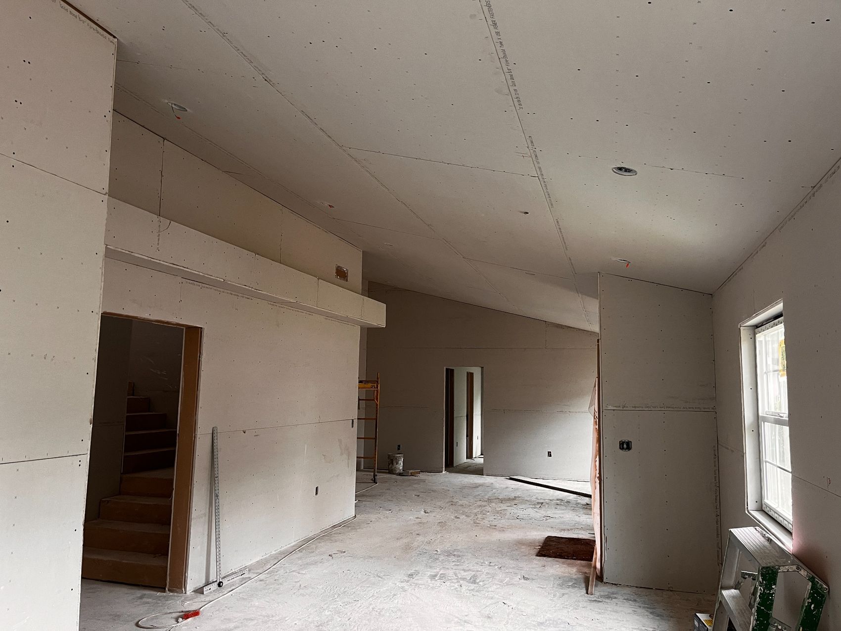 New drywall installed across walls and ceilings