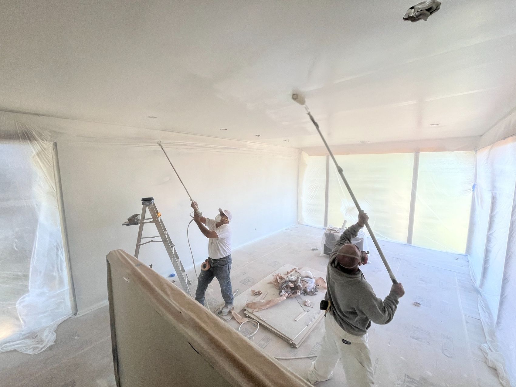 Our painting crew rolling a ceiling during an interior project