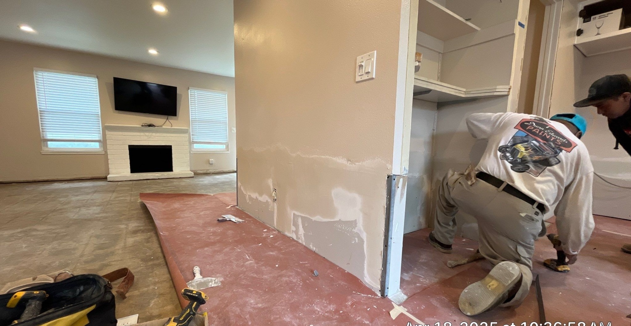 Drywall repair work in progress inside a home before painting