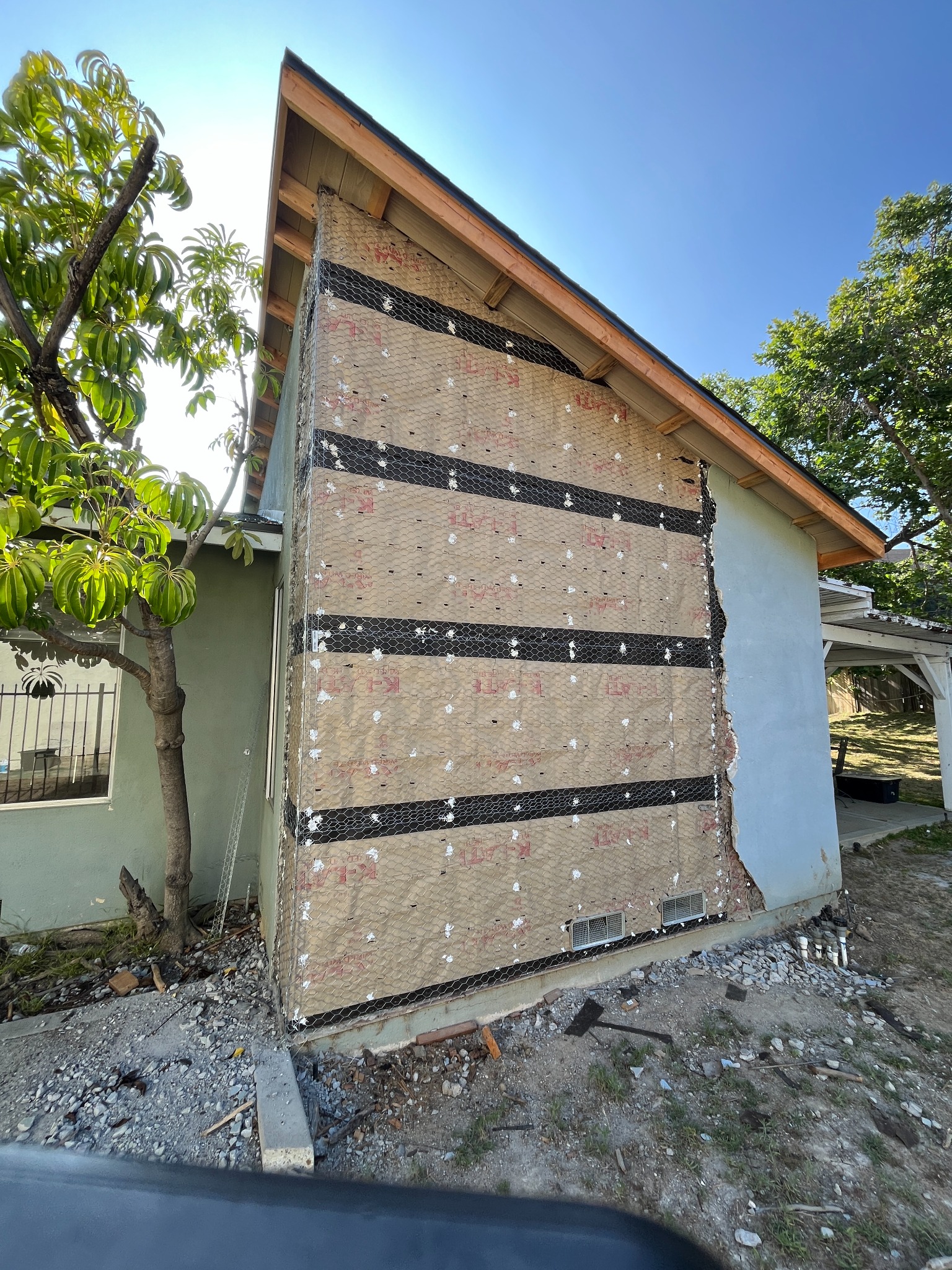 Exterior wall prepped with paper and lath for stucco repair
