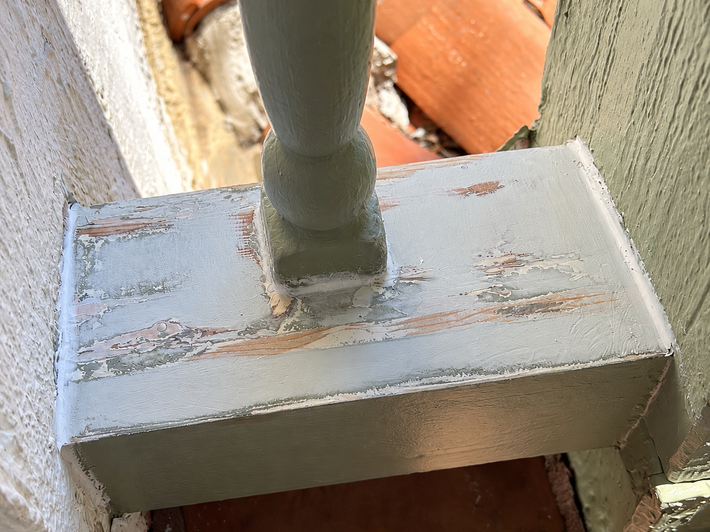 Exterior wood repair on a damaged railing base before painting